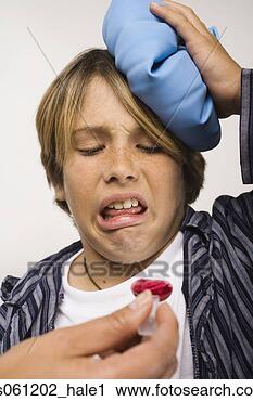 Stock Photography - sick boy being 
given cough syrup. 
fotosearch - search 
stock photos, 
pictures, images, 
and photo clipart