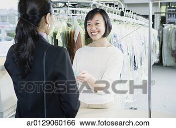 Stock Photo - smiling asian 
drycleaner, edmonds, 
washington, united 
states. fotosearch 
- search stock 
photos, pictures, 
images, and photo 
clipart