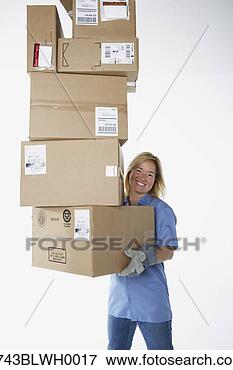 Picture - studio shot of 
female warehouse 
worker carrying 
packages. fotosearch 
- search stock 
photos, pictures, 
images, and photo 
clipart