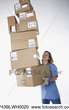 Stock Photography - studio shot of 
female warehouse 
worker carrying 
packages. fotosearch 
- search stock 
photos, pictures, 
images, and photo 
clipart
