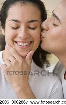 Picture - studio shot of 
hispanic man kissing 
hispanic woman's 
cheek. fotosearch 
- search stock 
photos, pictures, 
images, and photo 
clipart