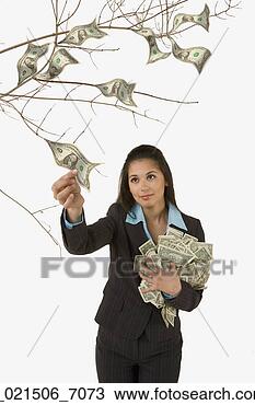 Stock Photo - studio shot of 
woman plucking 
money off of money 
tree. fotosearch 
- search stock 
photos, pictures, 
images, and photo 
clipart
