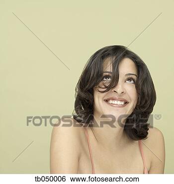Stock Photo - studio shot of 
young hispanic 
woman smiling. 
fotosearch - search 
stock photos, 
pictures, images, 
and photo clipart