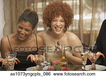 Stock Photo - two young african 
women laughing 
at a dinner party, 
 richmond. fotosearch 
- search stock 
photos, pictures, 
images, and photo 
clipart