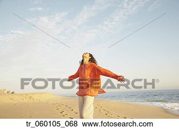 Stock Photo - woman with arms 
outstretched at 
the beach, los 
cabos, mexico. 
fotosearch - search 
stock photos, 
pictures, images, 
and photo clipart