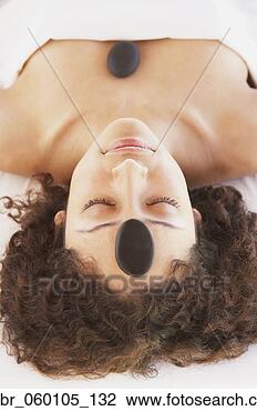 Stock Photo - woman with spa 
treatment stones 
on her head and 
chest,  los cabos. 
fotosearch - search 
stock photos, 
pictures, images, 
and photo clipart