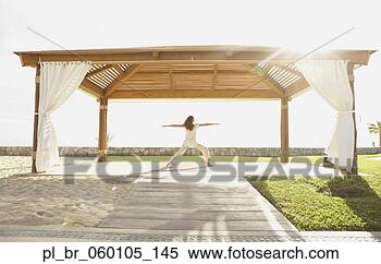 Stock Image - woman doing yoga 
a beach resort, 
los cabos, mexico. 
fotosearch - search 
stock photos, 
pictures, images, 
and photo clipart