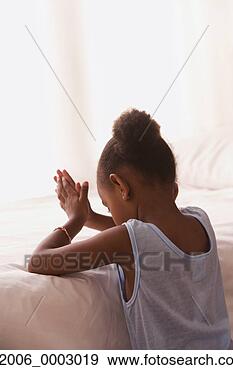 Stock Photograph - young african 
girl praying at 
her bedside. fotosearch 
- search stock 
photos, pictures, 
images, and photo 
clipart