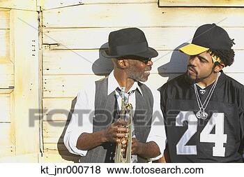 Stock Photo - young african 
man talking to 
senior african 
man with trumpet. 
fotosearch - search 
stock photos, 
pictures, images, 
and photo clipart