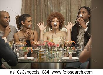 Stock Photo - young african 
woman balancing 
a spoon on her 
nose at a dinner 
party. fotosearch 
- search stock 
photos, pictures, 
images, and photo 
clipart