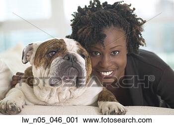 Stock Photography - young african 
woman smiling 
with british bulldog. 
fotosearch - search 
stock photos, 
pictures, images, 
and photo clipart