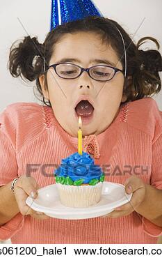 Stock Photography - young girl with  birthday cupcake.  fotosearch - search  stock photos,  pictures, wall  murals, images,  and photo clipart