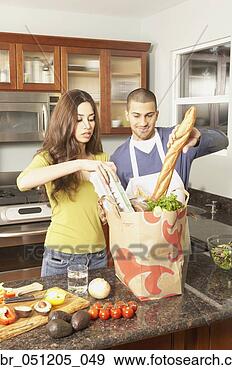 Stock Photograph - young hispanic 
couple unpacking 
grocery bag,  
san rafael. fotosearch 
- search stock 
photos, pictures, 
images, and photo 
clipart