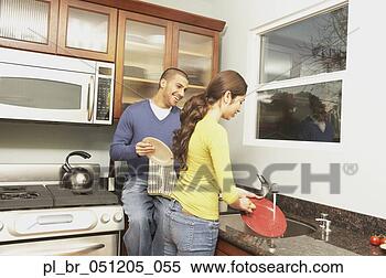 Stock Image - young hispanic 
couple washing 
dishes,  san rafael, 
 california. fotosearch 
- search stock 
photos, pictures, 
images, and photo 
clipart