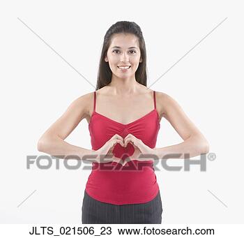 Stock Photo - young hispanic 
woman making a 
heart shape with 
her hands in front 
of. fotosearch 
- search stock 
photos, pictures, 
images, and photo 
clipart