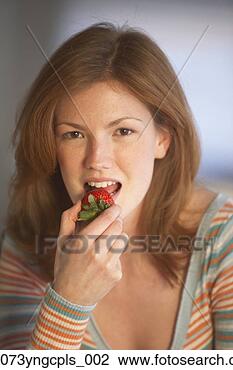 Stock Photo - young woman eating 
a strawberry, 
richmond, virginia, 
united states. 
fotosearch - search 
stock photos, 
pictures, images, 
and photo clipart