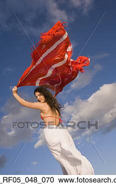 Stock Photography - young woman holding 
shawl over her 
head in the wind. 
fotosearch - search 
stock photos, 
pictures, images, 
and photo clipart