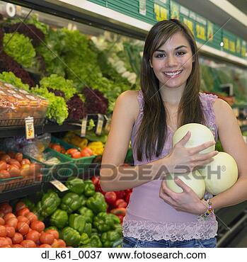 Picture - young woman holding 
melons in produce 
section of supermarket, 
 perth. fotosearch 
- search stock 
photos, pictures, 
images, and photo 
clipart