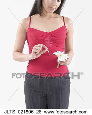 Stock Photo - young woman pulling 
a petal off a 
flower. fotosearch 
- search stock 
photos, pictures, 
images, and photo 
clipart