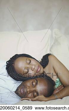 Stock Photograph - african american 
couple sleeping 
on sofa. fotosearch 
- search stock 
photos, pictures, 
images, and photo 
clipart