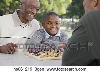 Stock Photo - african american 
family playing 
chess. fotosearch 
- search stock 
photos, pictures, 
images, and photo 
clipart