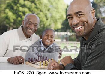 Stock Photo - african american 
family with chessboard 
outdoors. fotosearch 
- search stock 
photos, pictures, 
images, and photo 
clipart