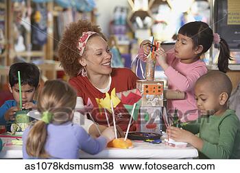 Stock Photo - african american 
female art teacher 
with young students. 
fotosearch - search 
stock photos, 
pictures, images, 
and photo clipart