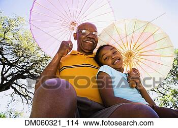Stock Photo - african american 
grandfather and 
granddaughter 
with parasols. 
fotosearch - search 
stock photos, 
pictures, images, 
and photo clipart