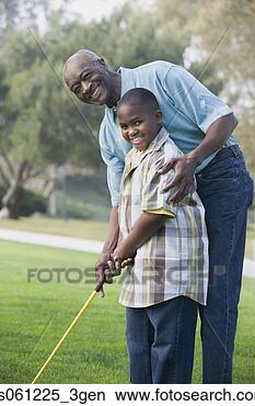 Stock Photo - african american 
grandfather and 
grandson playing 
golf. fotosearch 
- search stock 
photos, pictures, 
images, and photo 
clipart
