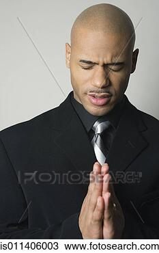 Stock Photo - african american 
man in suit praying. 
fotosearch - search 
stock photos, 
pictures, images, 
and photo clipart