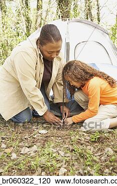 Stock Photography - african american 
mother and daughter 
setting up tent. 
fotosearch - search 
stock photos, 
pictures, images, 
and photo clipart