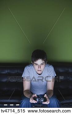 Stock Image - boy playing video 
game on sofa. 
fotosearch - search 
stock photos, 
pictures, images, 
and photo clipart
