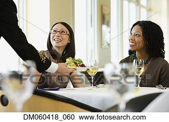 Stock Photography - businesswomen 
being served in 
restaurant. fotosearch 
- search stock 
photos, pictures, 
images, and photo 
clipart