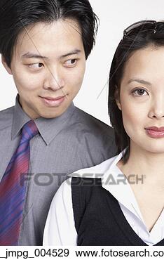 Stock Photograph - close up of asian 
businessman looking 
at asian businesswoman. 
fotosearch - search 
stock photos, 
pictures, images, 
and photo clipart