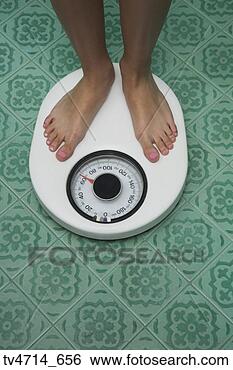 Stock Photo - close up of bare 
feet on bathroom 
scale. fotosearch 
- search stock 
photos, pictures, 
images, and photo 
clipart
