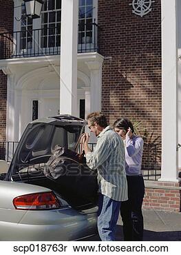 Stock Image - couple loading 
trunk of car. 
fotosearch - search 
stock photos, 
pictures, images, 
and photo clipart