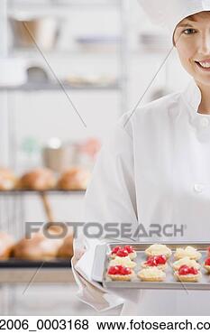 Stock Photo - female pastry 
chef with tray 
of tarts. fotosearch 
- search stock 
photos, pictures, 
images, and photo 
clipart