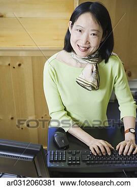 Stock Photography - middle-aged asian 
businesswoman 
smiling. fotosearch 
- search stock 
photos, pictures, 
images, and photo 
clipart