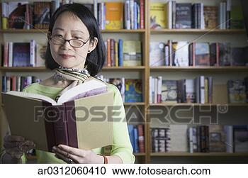 Stock Photography - middle-aged asian 
woman reading 
book. fotosearch 
- search stock 
photos, pictures, 
images, and photo 
clipart
