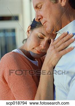 Stock Photo - middle-aged couple 
hugging with eyes 
closed. fotosearch 
- search stock 
photos, pictures, 
images, and photo 
clipart