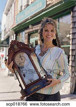 Stock Photo - middle-aged woman 
holding antique 
clock. fotosearch 
- search stock 
photos, pictures, 
images, and photo 
clipart