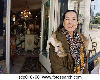 Stock Photo - middle-aged woman 
standing in front 
of antique shop. 
fotosearch - search 
stock photos, 
pictures, images, 
and photo clipart