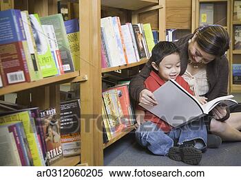 Stock Image - mother and young 
son reading book 
at bookstore. 
fotosearch - search 
stock photos, 
pictures, images, 
and photo clipart