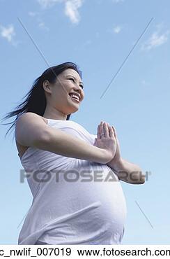 Stock Photograph - pregnant asian 
woman doing yoga 
outdoors. fotosearch 
- search stock 
photos, pictures, 
images, and photo 
clipart