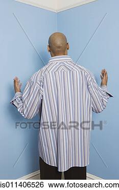 Stock Photo - rear view of african 
american man facing 
corner. fotosearch 
- search stock 
photos, pictures, 
images, and photo 
clipart