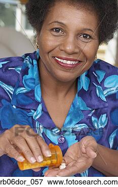 Picture - senior african 
american woman 
with medication. 
fotosearch - search 
stock photos, 
pictures, images, 
and photo clipart