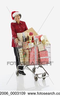 Stock Photograph - senior hispanic 
woman with shopping 
cart full of gifts. 
fotosearch - search 
stock photos, 
pictures, images, 
and photo clipart