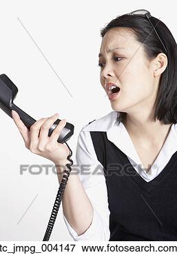 Picture - studio shot of 
asian businesswoman 
yelling at telephone. 
fotosearch - search 
stock photos, 
pictures, images, 
and photo clipart