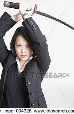 Stock Photo - studio shot of 
asian businesswoman 
holding sword. 
fotosearch - search 
stock photos, 
pictures, images, 
and photo clipart
