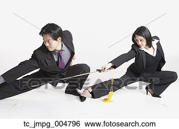 Stock Photo - studio shot of 
asian businesspeople 
with swords. fotosearch 
- search stock 
photos, pictures, 
images, and photo 
clipart